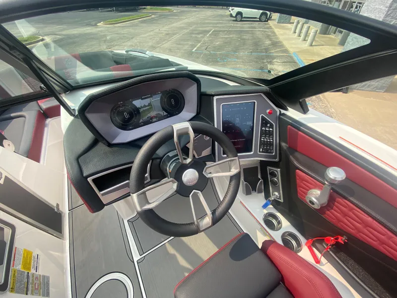 Slide: The Image of 2022 MasterCraft X24 boat dashboard with modern controls and steering wheel. - 37