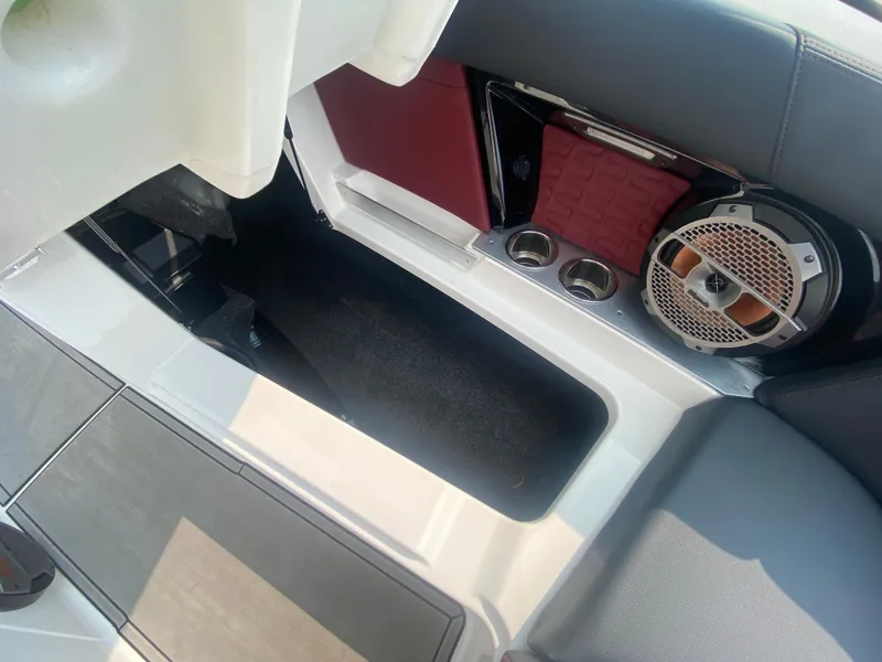 Slide: The Image of 2022 MasterCraft X24 interior with speaker, cup holders, and storage compartment. - 42