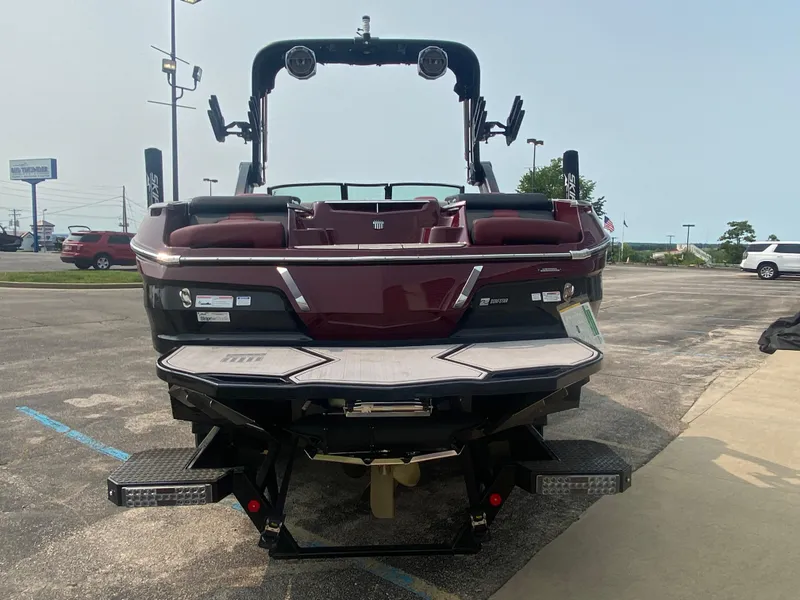 Slide: The Image of 2022 MasterCraft X24 boat, rear view, parked in a lot. - 6