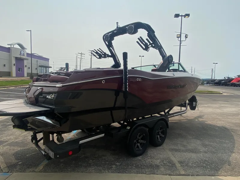 Slide: The Image of 2022 MasterCraft X24 boat on trailer in parking lot, side view. - 7