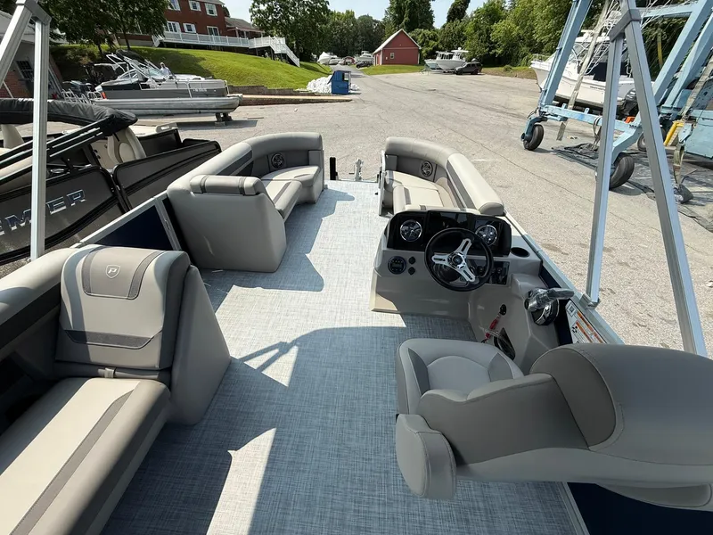 Slide: The Image of 2025 Premier 200 Sunscape RE XLC pontoon boat interior with plush seating and steering console. - 10