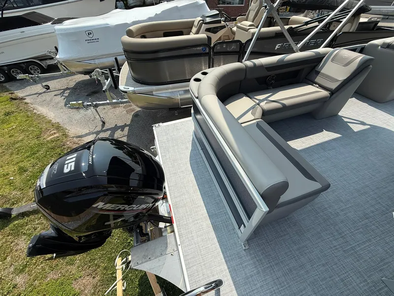 Slide: The Image of 2025 Premier 200 Sunscape RE XLC pontoon boat with Mercury outboard motor, docked outdoors. - 8