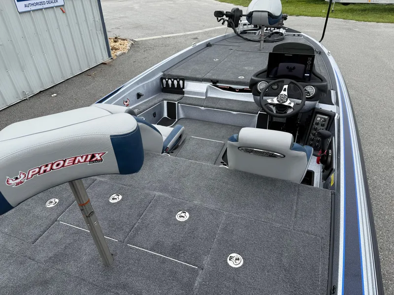 Slide: The Image of 2026 Phoenix 721 ZXL boat interior with steering console and seating. - 11