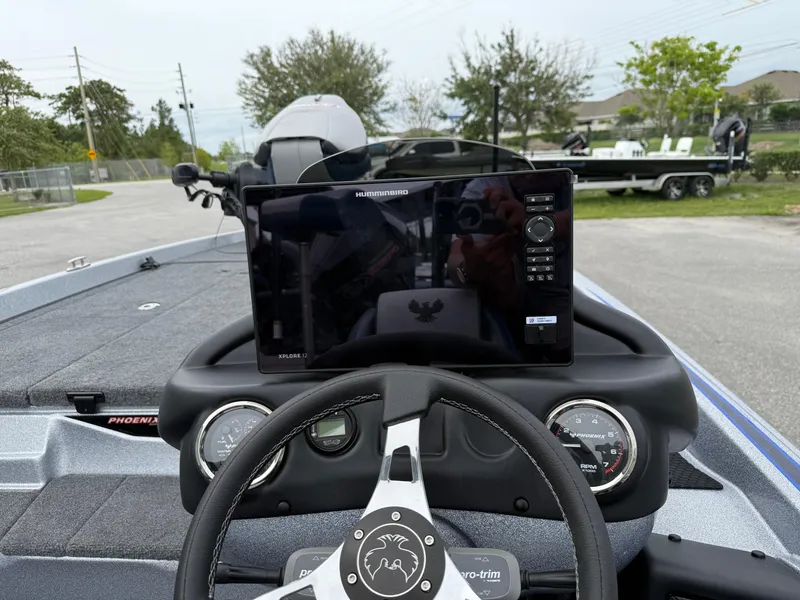 Slide: The Image of Dashboard of a 2026 Phoenix 721 ZXL boat with steering wheel and electronic display. - 13
