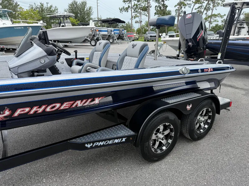 Slide: The Image of 2026 Phoenix 721 ZXL boat with dual seats and trailer in a parking lot. - 4