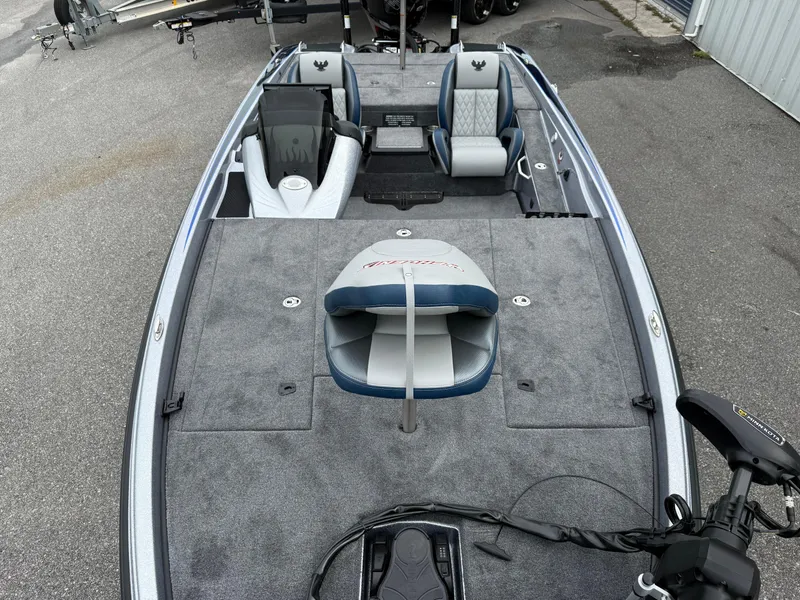 Slide: The Image of 2026 Phoenix 721 ZXL boat interior with seating and fishing deck, parked on pavement. - 5