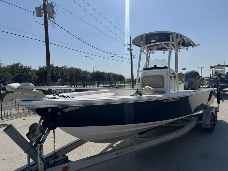 Slide: The Image of 2017 Sportsman Masters 247 Bay Boat on trailer, parked outdoors under clear sky. - 10