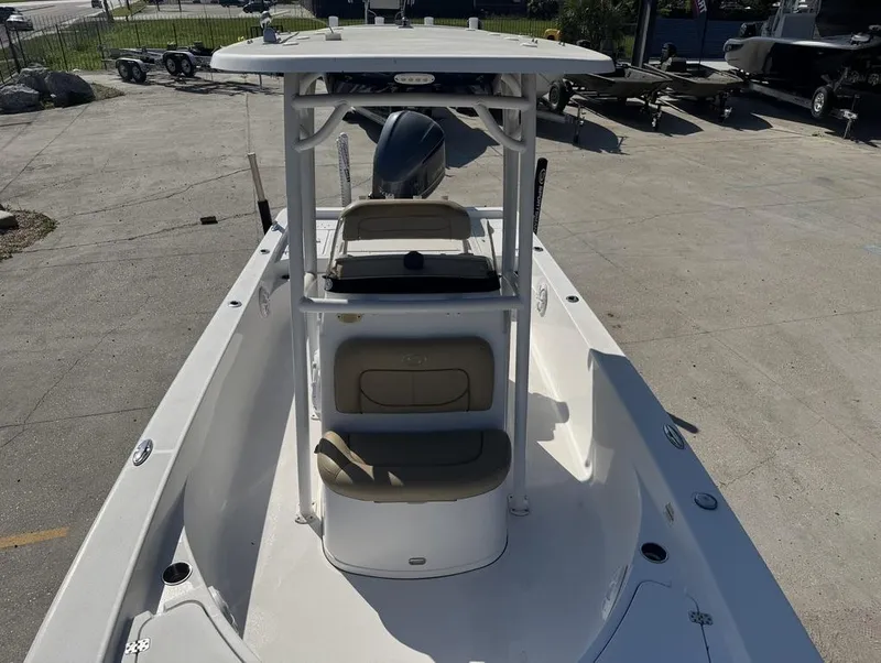 Slide: The Image of 2017 Sportsman Masters 247 Bay Boat with T-top and seating, parked on concrete. - 7