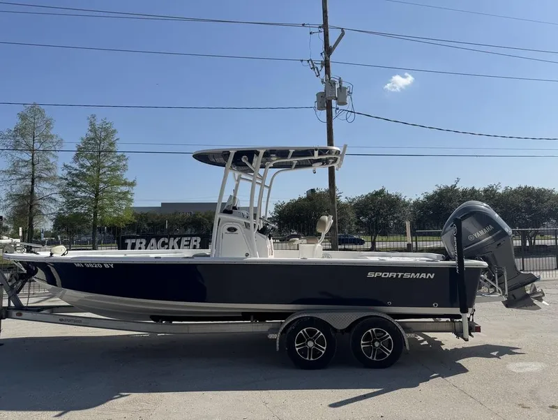 Slide: The Image of 2017 Sportsman Masters 247 Bay Boat on trailer, parked outdoors under clear sky. - 9