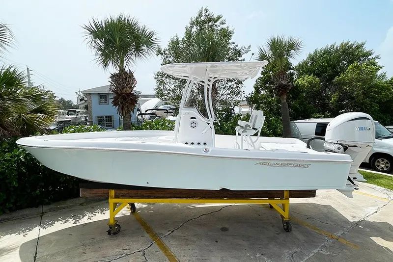 Slide: The Image of 2024 Aquasport 230 Pro Bay boat on display with Yamaha outboard motor. - 1