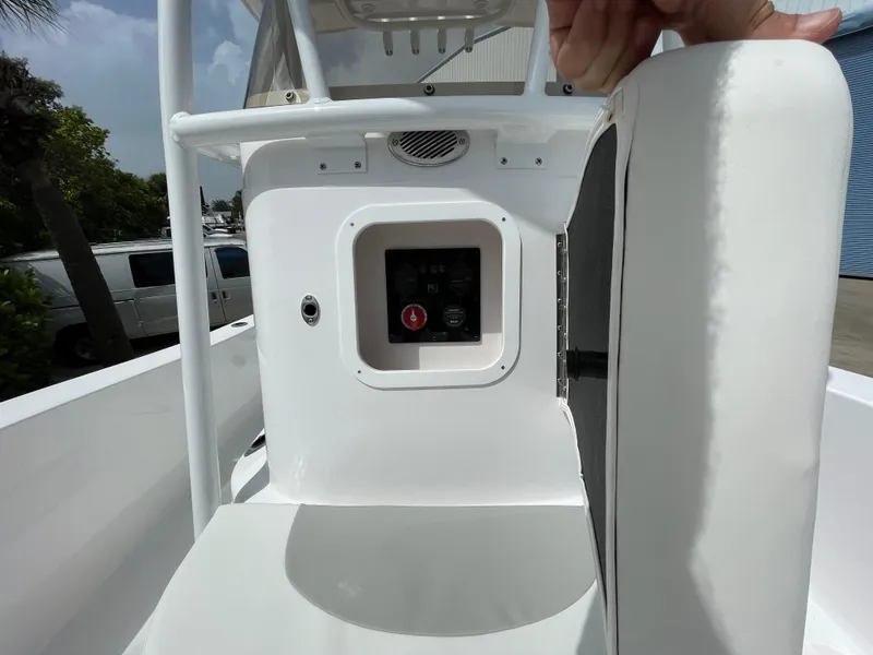 Slide: The Image of 2024 Aquasport 230 Pro Bay boat console with open storage compartment. - 11