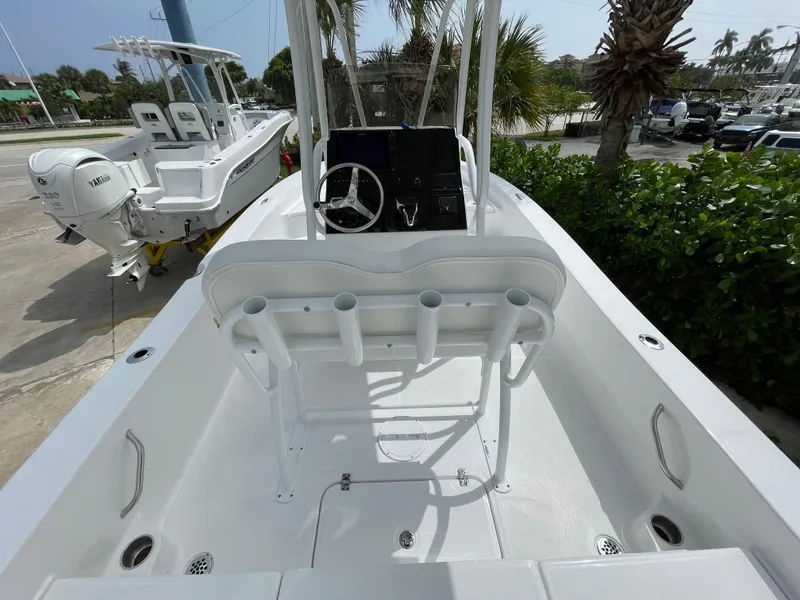 Slide: The Image of 2024 Aquasport 230 Pro Bay boat interior with steering console and rod holders. - 16
