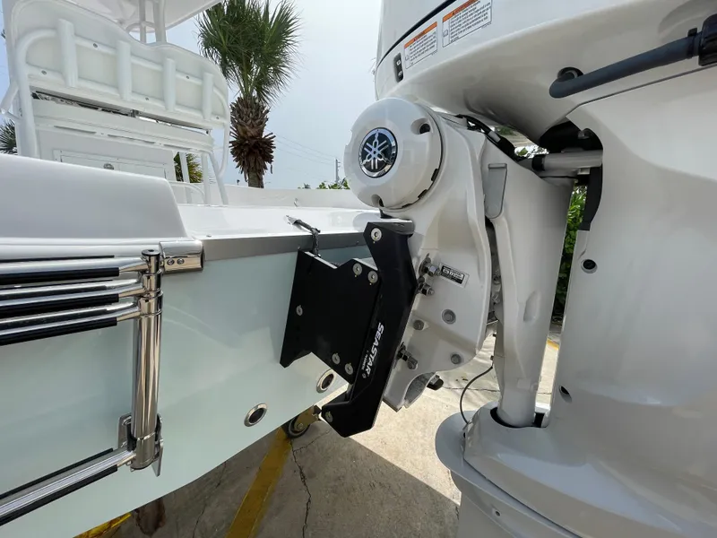 Slide: The Image of 2024 Aquasport 230 Pro Bay boat with Yamaha outboard motor, close-up view. - 22