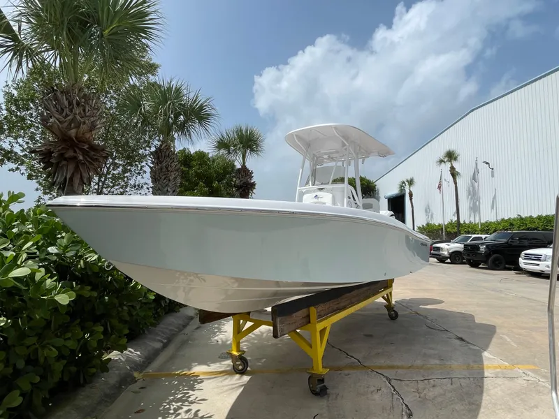 Slide: The Image of 2024 Aquasport 230 Pro Bay boat on trailer, parked outdoors near palm trees. - 27
