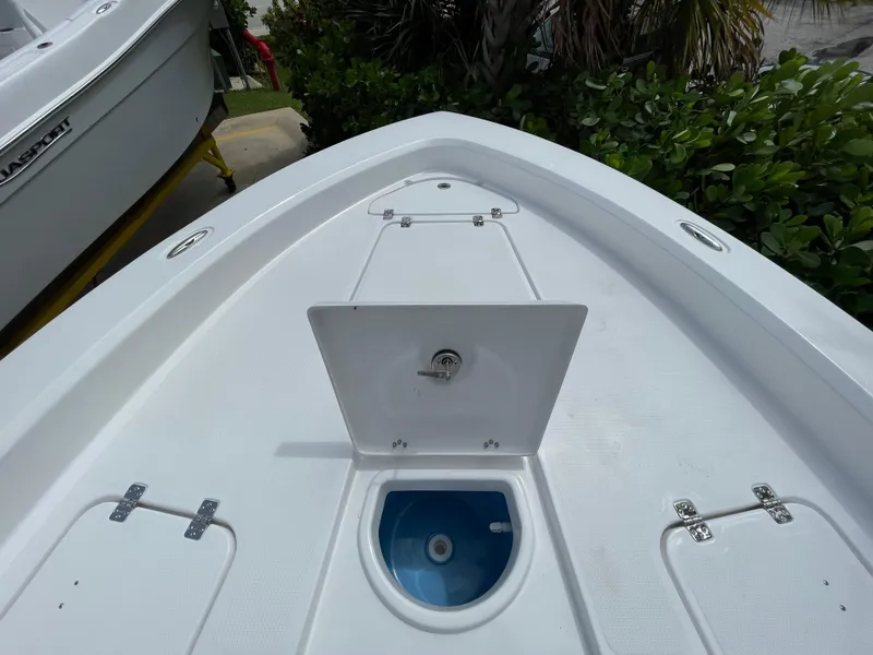 Slide: The Image of 2024 Aquasport 230 Pro Bay boat deck with open storage compartment. - 5