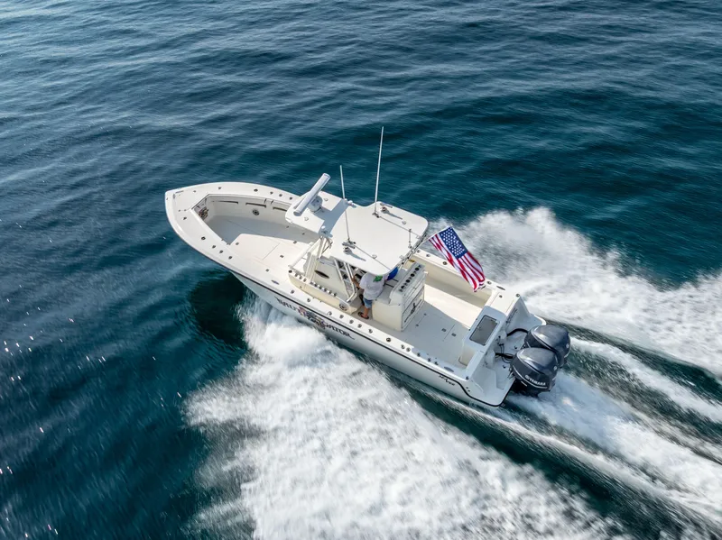 Slide: The Image of 2014 SeaVee 34 boat cruising on open water with American flag. - 10