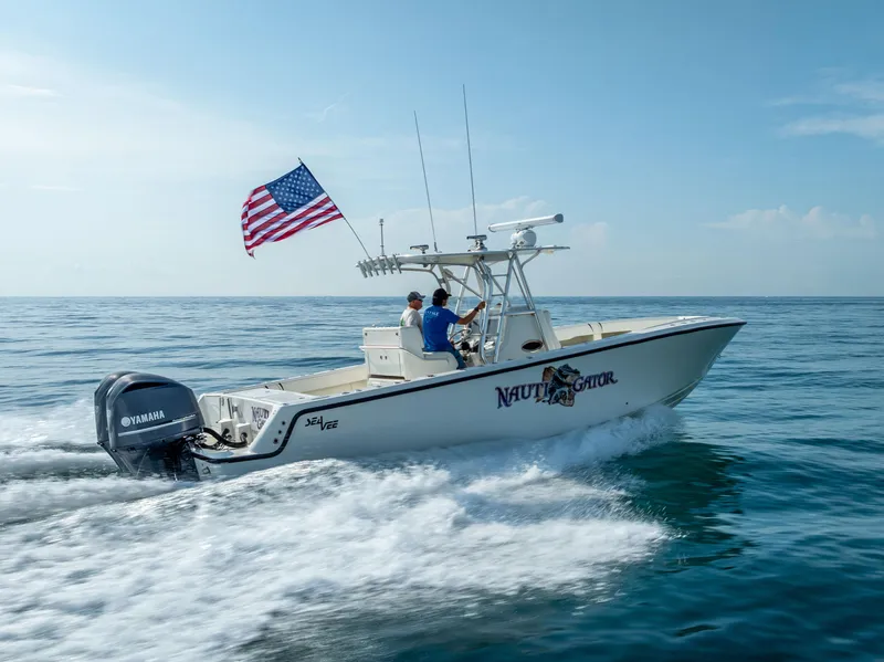 Slide: The Image of 2014 SeaVee 34 boat cruising on ocean with American flag and Yamaha engine. - 12