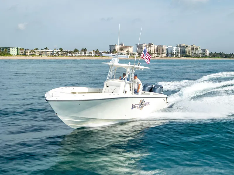 Slide: The Image of 2014 SeaVee 34 boat cruising on ocean near coastal buildings. - 15