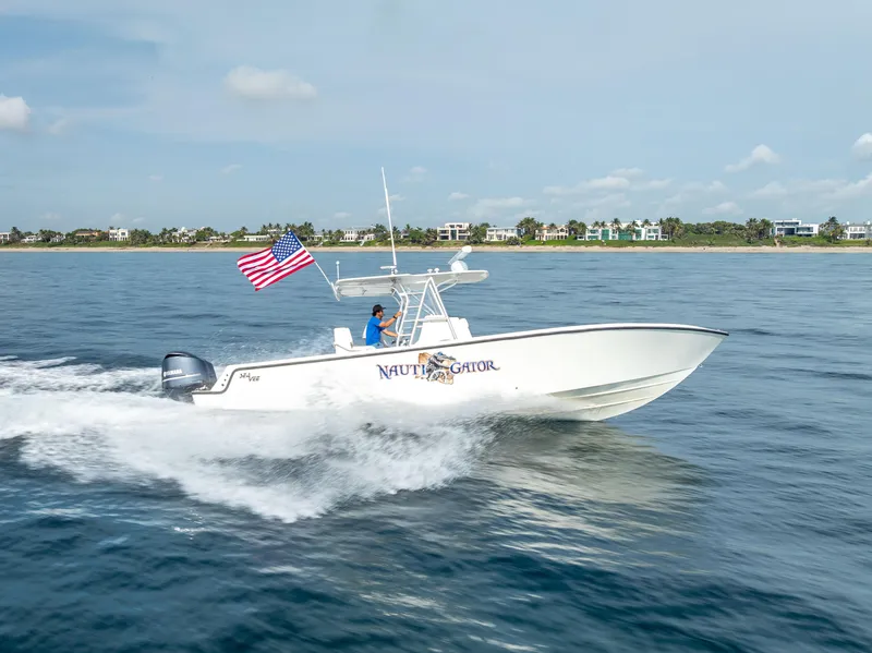 Slide: The Image of 2014 SeaVee 34 boat cruising on open water with American flag. - 16