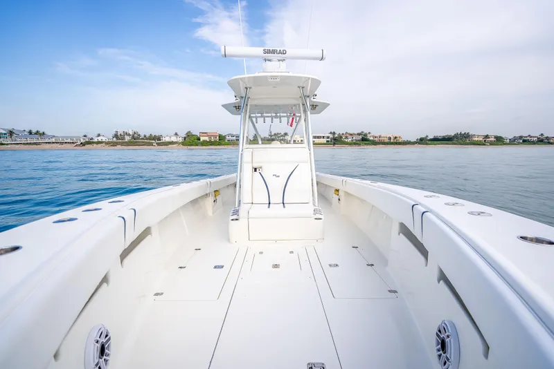 Slide: The Image of 2014 SeaVee 34 boat on calm water, showcasing spacious deck and modern design. - 19