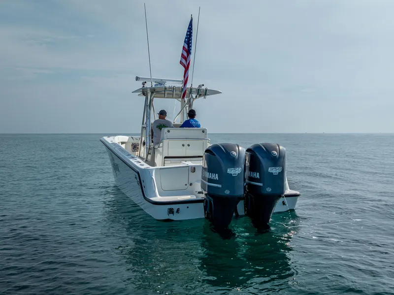 Slide: The Image of 2014 SeaVee 34 boat with dual Yamaha engines on calm ocean waters. - 2