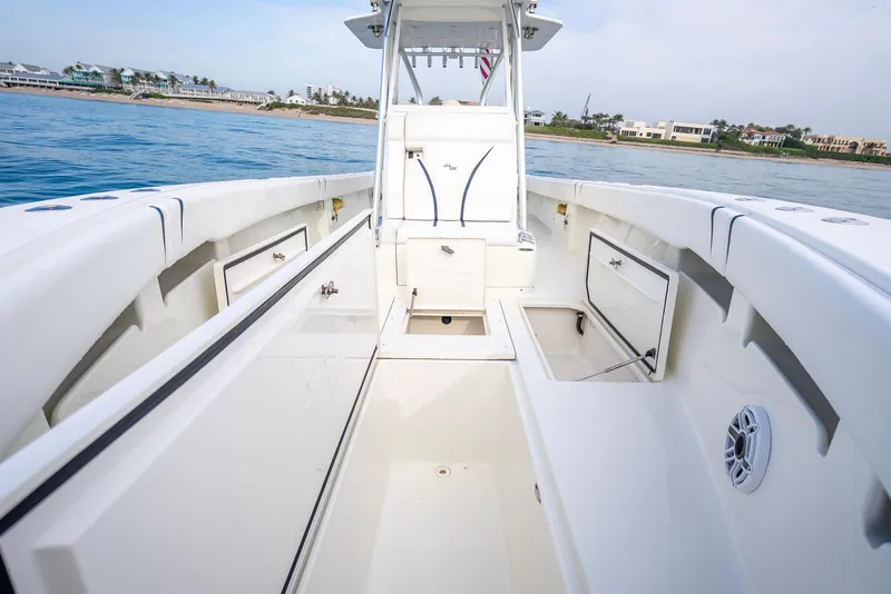 Slide: The Image of 2014 SeaVee 34 boat interior with open storage compartments, on calm blue water. - 22