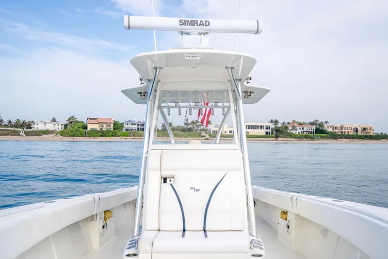 Slide: The Image of 2014 SeaVee 34 boat on water, featuring Simrad equipment, with coastal homes in the background. - 24
