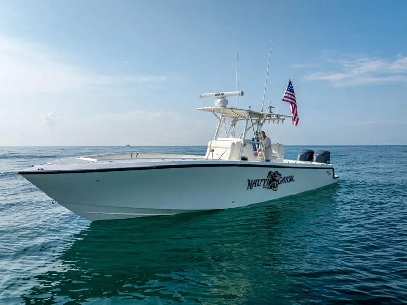 Slide: The Image of 2014 SeaVee 34 boat on calm ocean with American flag. - 3