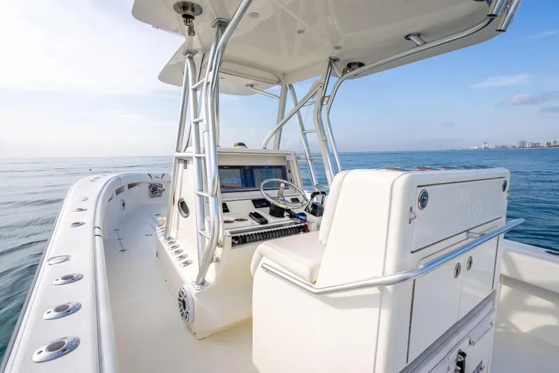 Slide: The Image of 2014 SeaVee 34 boat on open water, featuring a sleek console and spacious deck. - 31
