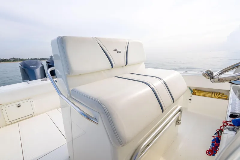 Slide: The Image of 2014 SeaVee 34 boat interior with white cushioned seating and ocean view. - 33