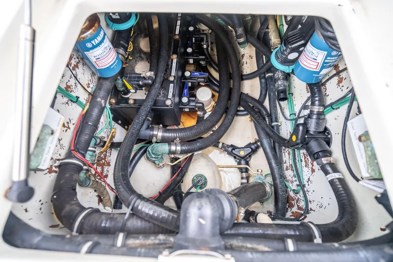 Slide: The Image of Engine compartment of a 2014 SeaVee 34 boat, featuring Yamaha components and various hoses. - 41