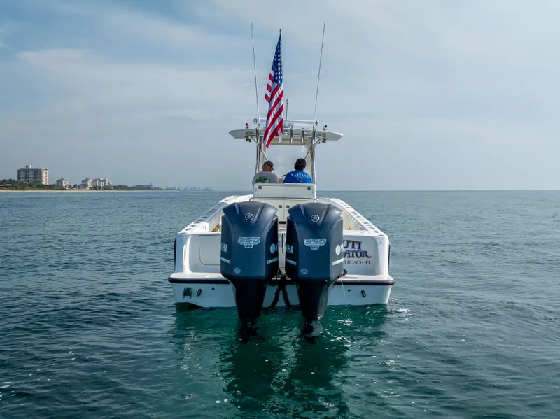 Slide: The Image of 2014 SeaVee 34 boat with dual outboard motors on calm ocean water. - 6