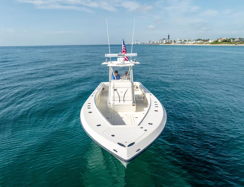 Slide: The Image of 2014 SeaVee 34 boat on calm ocean, clear sky, distant shoreline. - 8