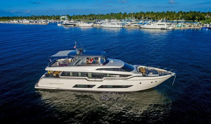 Slide: The Image of 2018 Ferretti Yachts 850 Motoryacht cruising on a sunny day near a marina. - 1