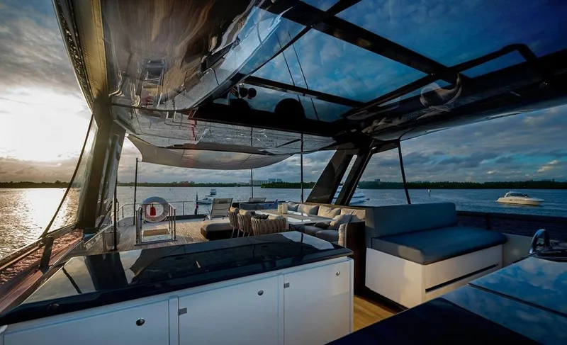 Slide: The Image of Luxurious 2018 Ferretti Yachts 850 Motoryacht interior with sunset view over the water. - 4