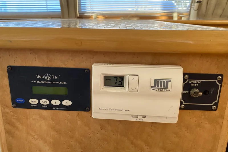 Slide: The Image of Cozy Navigator 5300 Classic 1998 yacht interior with sofa, decorative pillows, and wooden coffee table. - 10