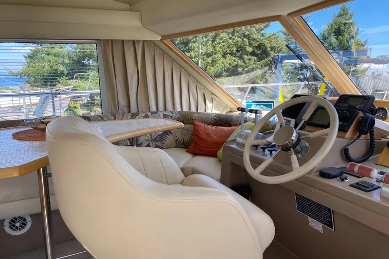 Slide: The Image of Interior of 1998 Navigator 5300 Classic yacht with built-in TV and wooden cabinetry. - 12