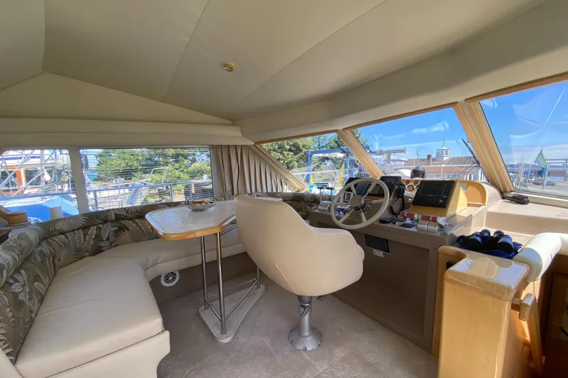 Slide: The Image of Interior of 1998 Navigator 5300 Classic yacht with steering wheel and seating area. - 13