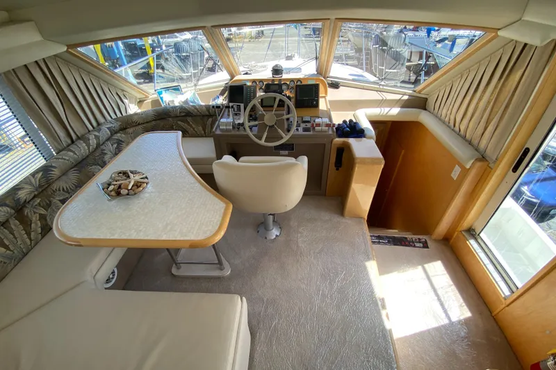 Slide: The Image of Interior of 1998 Navigator 5300 Classic yacht with helm, seating, and panoramic windows. - 14