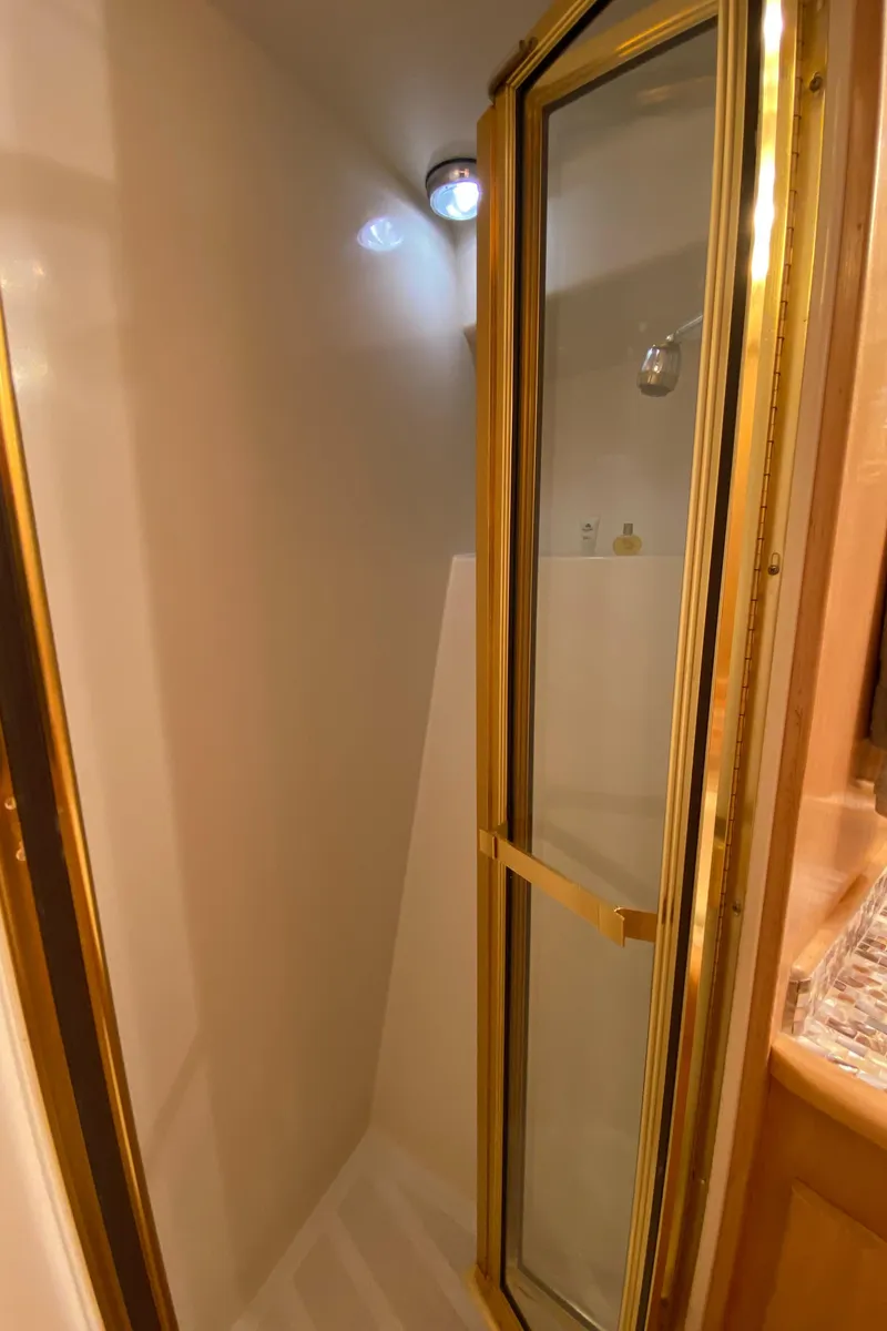 Slide: The Image of Cozy forward stateroom in 1998 Navigator 5300 Classic yacht with plush bedding and ambient lighting. - 21