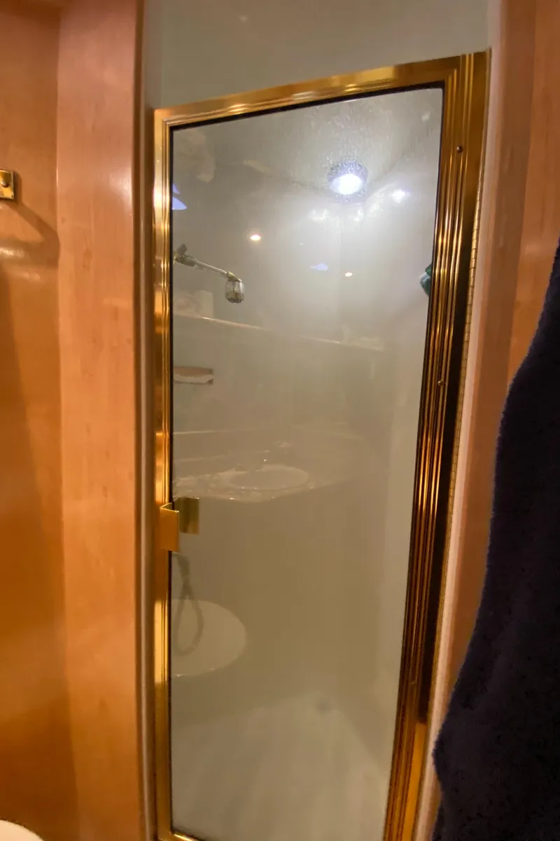 Slide: The Image of Luxurious head in 1998 Navigator 5300 Classic yacht with elegant fixtures and ample storage. - 24