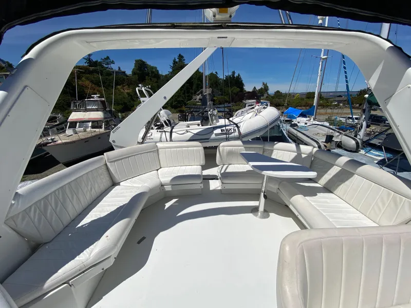 Slide: The Image of 1998 Navigator 5300 Classic tender with Honda outboard motor, docked under clear blue sky. - 30