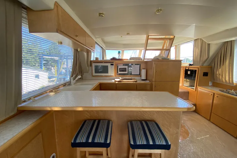 Slide: The Image of Spacious deck of 1998 Navigator 5300 Classic yacht, docked with other boats. - 4