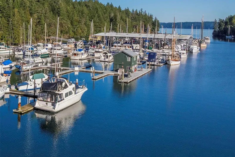 Slide: The Image of Marina with various boats, including a 1998 Navigator 53, surrounded by lush greenery. - 46