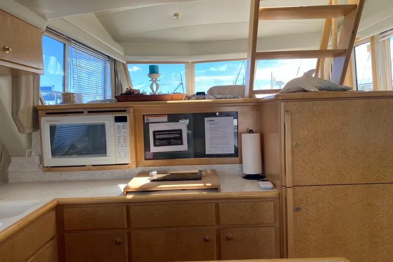 Slide: The Image of Luxurious interior of a 1998 Navigator 5300 Classic yacht with modern galley and cozy seating area. - 6
