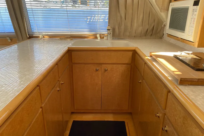 Slide: The Image of Interior of 1998 Navigator 5300 Classic yacht galley with microwave and wooden cabinetry. - 7
