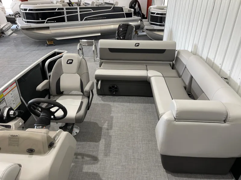 Slide: The Image of 2025 Princecraft Vectra 21 RL pontoon boat interior with gray seating and steering console. - 12