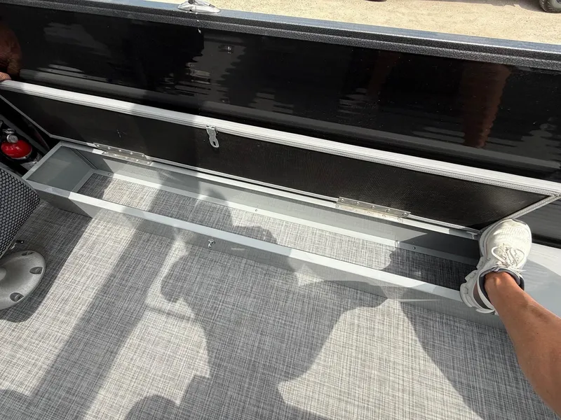 Slide: The Image of 2018 Misty Harbor 2085 Biscayne Bay FS boat storage compartment with open lid and footrest. - 26