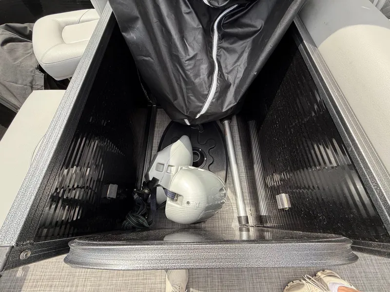 Slide: The Image of Storage compartment of 2018 Misty Harbor 2085 Biscayne Bay FS with helmet and cover. - 27