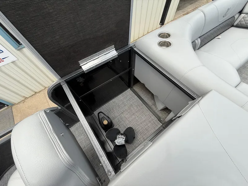 Slide: The Image of 2018 Misty Harbor 2085 Biscayne Bay FS boat interior storage compartment with cup holders. - 28